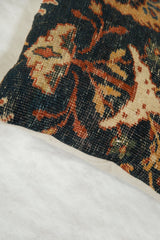 Close-up of antique Ziegler Mahal pillow, revealing textured dark teal and rust cypress tree motifs and beige trim.