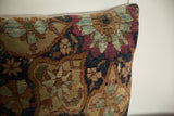Close-up of antique Kerman pillow's lustrous wool pile, showing cochineal red and powder blue floral patterns.
