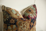 Angled view of antique Kerman pillow, lustrous cochineal red and abrashed powder blue pattern.