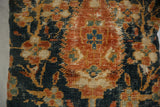 Ziegler Mahal pillow fragment detail: rust, dark blue, cream botanical design, visible threadbare texture.