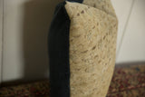 Vintage Turkish Sivas rug fragment pillow, dark fabric side, light faded woven texture.