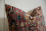 Textured vintage Meshed rug fragment with intricate border pattern in red, blue, and visible foundation.