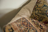 The textured woven backing and seam of an antique Kerman rug fragment pillow.