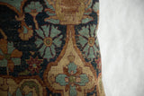 Antique Kerman fragment pillow displaying curvilinear floral motifs and aged patina.
