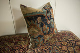 Antique Kerman pillow's lustrous wool surface with cochineal red, blue, and orange floral designs.