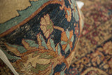Antique Kerman rug fragment pillow, close-up of abrashed powder blue and dusty orange floral patterns.
