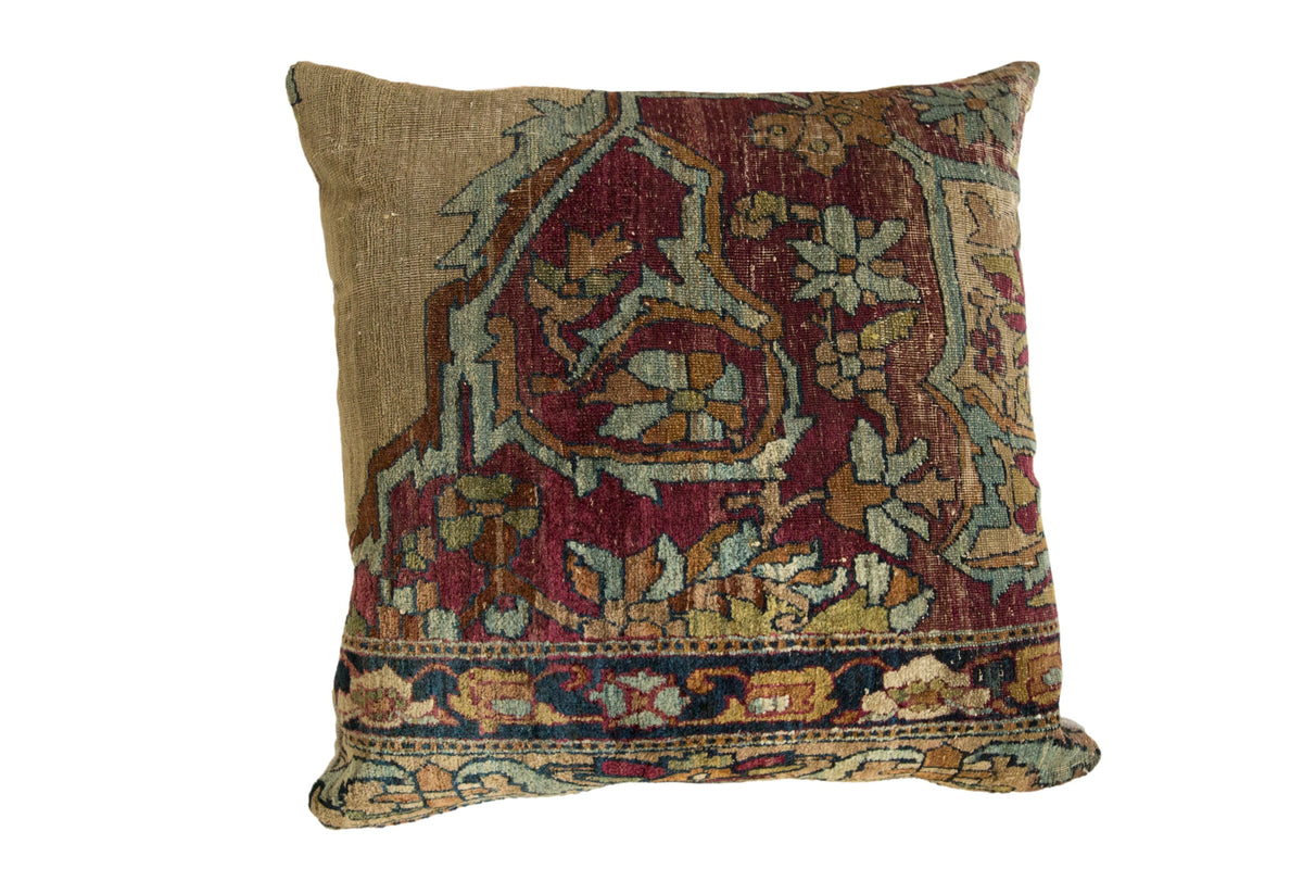 Antique Kerman rug fragment pillow with a floral motif in cochineal red, powder blue, and moss green.