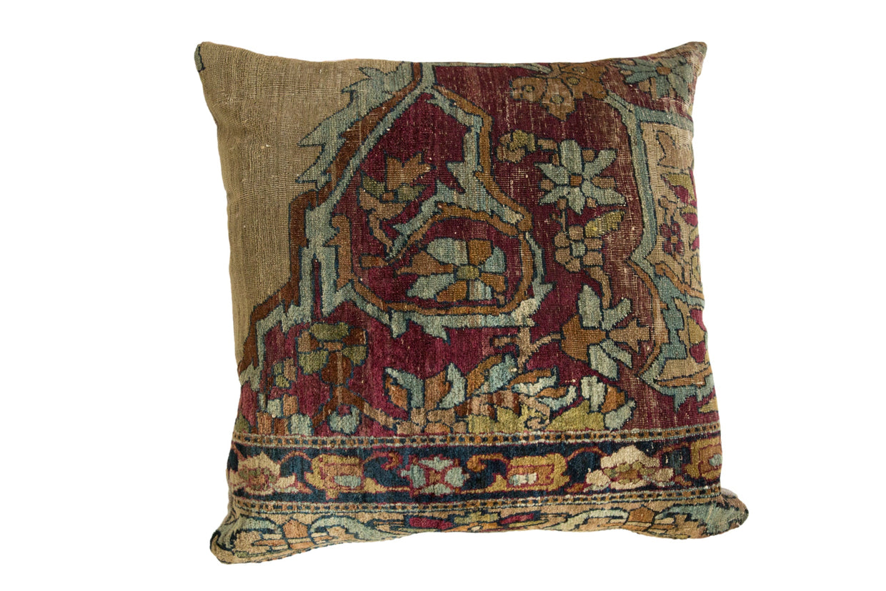 Antique Kerman rug fragment pillow with a floral motif in cochineal red, powder blue, and moss green.