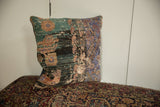 Decorative vintage Anatolian rug fragment pillow in distressed teal, lavender, and earth tones.
