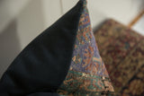 Angled corner of the vintage Anatolian rug fragment pillow, showing distressed geometric patterns and muted tones.