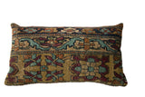 Antique Kerman rug fragment pillow with floral motifs and turtle-like cartouches on an ochre gold ground.