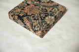 Corner view of the antique Fereghan rug art showing the textured pile and wrapped edge.