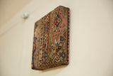 Side profile of the decorative cork board showing the wrapped antique Fereghan rug texture.