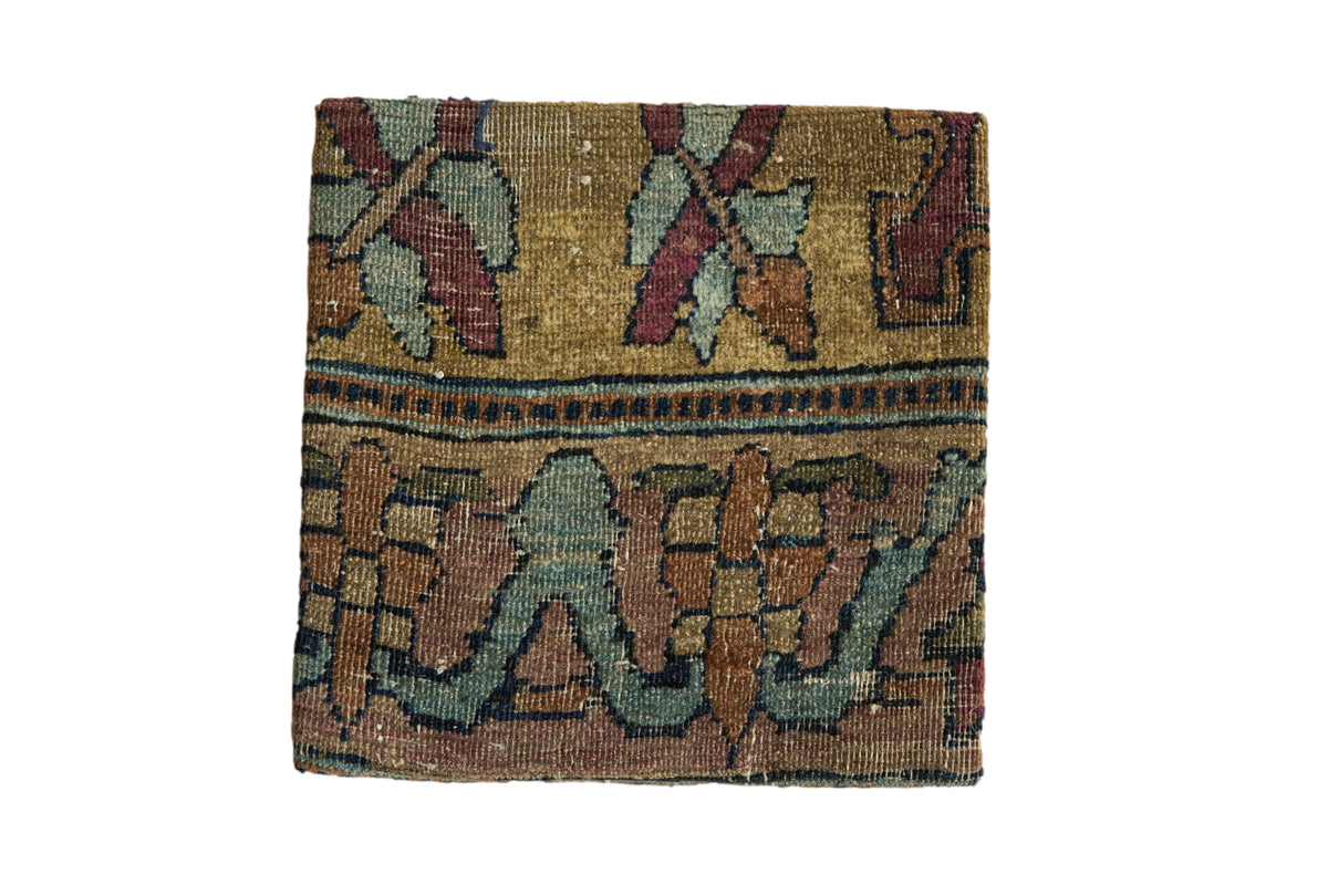 Antique Kerman rug fragment cork board with floral motifs in gold, muted red, and blue-green.