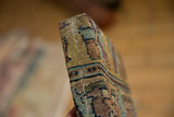 Side profile showing the deep, wrapped edge and stitched corner of the antique rug art.