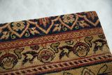 Corner detail of the antique Kerman rug art showing its low, hand-knotted pile.