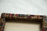 Sawtooth hanging hardware attached to the back of the framed antique Kerman rug fragment art.