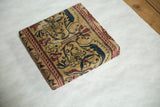 Angled view of the decorative cork board showing its wrapped sides and antique Kerman fragment.