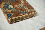 The hand-knotted wool pile and wrapped edge of a decorative antique rug fragment cork board.