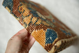 Side view showing the two-inch depth and antique woven wool texture of the rug art cork board.