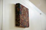 Wrapped antique Kerman rug fragment with sapphire blue and cochineal red thousand flower motif.