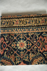 Profile view of the antique rug art cork board showing its thickness and hand-knotted Fereghan texture.