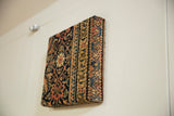 Thick profile of the Fereghan rug art, showing the germinating vine border wrapped around the deep edge.