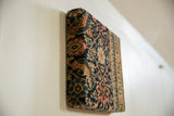 Side profile view of the decorative cork board showing its depth and antique Fereghan rug fragment texture.