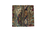 Decorative cork board made from an antique Kerman rug fragment with colorful traditional patterns.