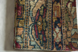 Profile view of the antique rug fragment art, showing its substantial depth and textured wool pile.