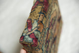 Detailed view of the thick corner, wrapped in antique Kerman wool with a plush pile.
