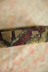 Side profile of the antique Kerman rug fragment highlighting its thick, silk-like wool pile.