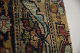 Detailed texture of the hand-knotted, silk-like wool pile of an antique Kerman rug.
