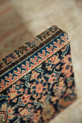 Angled corner view of the decorative cork board showing the thick, hand-knotted antique rug texture.