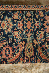 Classic floral and vine motifs on an antique Fereghan rug in navy blue and madder red.