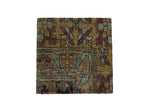 Decorative cork board from an antique Kerman rug fragment with geometric florals in muted green, red, and blue.