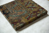 Corner view of the decorative cork board, highlighting the aged texture of the antique Kerman wool.