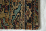 Corner detail of a late 18th-century Kerman rug fragment showing its threadbare texture and wool pile.