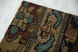 Low, glossy wool pile and visible foundation weave on the antique Kerman rug fragment.
