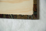 Back view detail of the cork board showing the mitered corner wrapped with antique rug fabric.