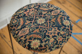 Overhead view of the antique Fereghan rug top's intricate navy and saffron woven pattern.
