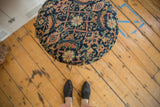 Top-down view detailing the intricate geometric pattern on the antique rug fragment side table.