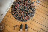 Reclaimed antique Persian Fereghan rug fragment cushioned top with ornate navy, saffron, and coral patterns.