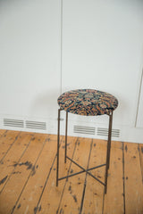 Full profile of the reclaimed side table showing its slender metal legs and folding X-brace base.