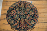 Overhead view of the side table's top, made from an antique Persian Fereghan rug fragment.