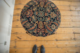 Overhead view showing the scale and circular pattern of the antique rug fragment side table.