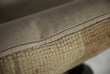 Distressed neutral beige Oushak rug fragment pillow pile and smooth woven backing.