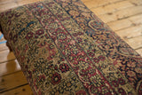 Close view of the antique Kerman rug's storied texture and time-softened floral pattern.
