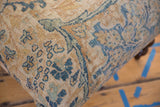 Detailed weave of a vintage Persian rug ottoman in dusty sapphire blue and gold.
