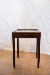 Painted vintage end table featuring a dark wood drawer and brass knob.